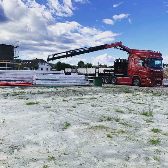 Trailer med kran løfter store elementer